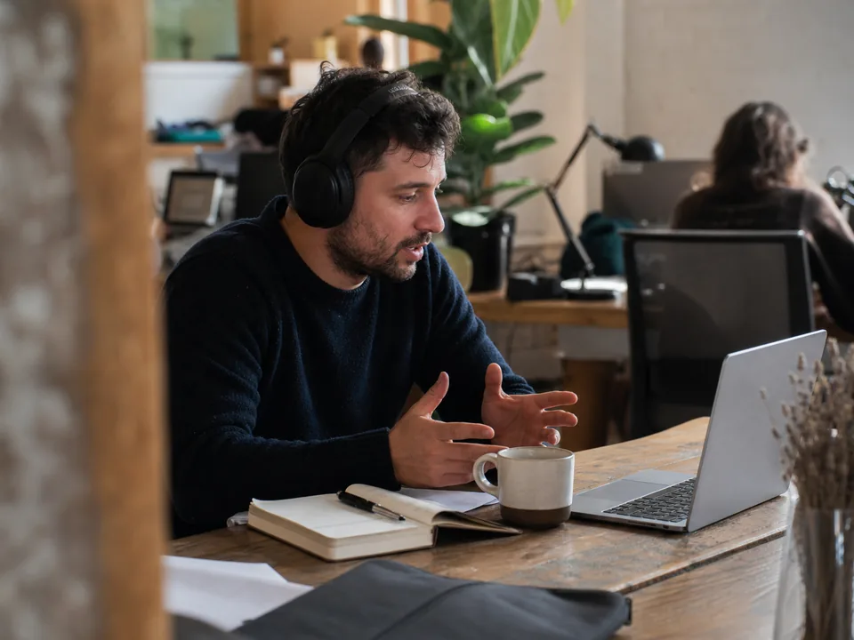 Software startup founder on a call with a prospect at a shared workspace desk